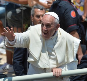 LAMPEDUSA, ITALY - JULY 08: Pope Francis waves to the faithful after visiting San Gerlando churcv during his visit to the island on July 8, 2013 in Lampedusa, Italy. On his first official trip outside Rome, Pope Francis arrived at Lampedusa airport, before boarding a boat to make the crossing to the island accompanied by fishermen in their own boats. He layed a wreath on the sea in memory of those who have lost their lives in the crossing to the island from Africa, met with a group of migrants at the pier and held mass. (Photo by Tullio M. Puglia/Getty Images)