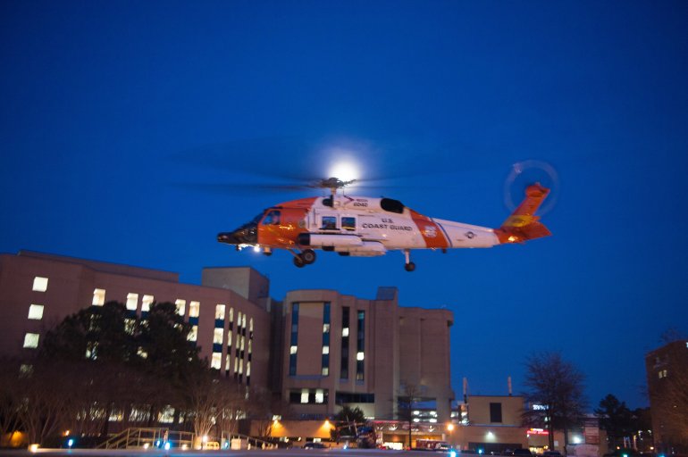 A Coast Guard MH-60 Jayhawk helicopter crew lands at Sentara Norfolk General Hospital in Norfolk, Va., Thursday, April 2, 2015, after medevacing Louis Jordan, 37, who had been missing for more than 60 days. Watchstanders at the Coast Guard 5th District Command Center in Portsmouth received notification from the 1,085-foot German-flagged motor vessel Houston Express at approximately 1:30 p.m. indicating they spotted the man on his vessel approximately 200 miles east of Cape Hatteras, N.C., and took him aboard.