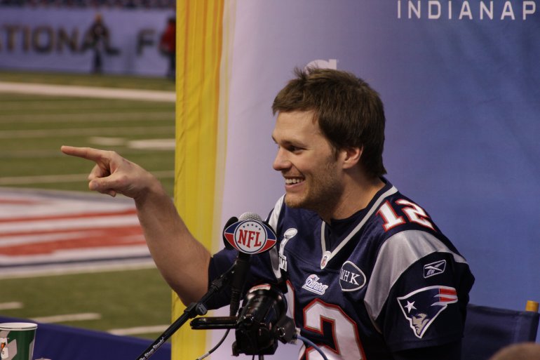 Tom Brady #12 of the New England Patriots answers questions from reporters during Super Bowl Media Day. On Super Bowl Media Day, sports reporters and some fans get to meet members of the New York Giants and New England Patriots football teams on Tuesday, January 31, 2012 ahead of Super Bowl XLVI at the Lucas Oil Stadium in Indianapolis, Indiana. The two teams are to face each other in the stadium on Sunday, February 5.