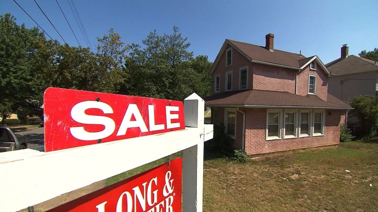 (FILE) A for sale sign sits on the front lawn of a home in the Washington, D.C. area.