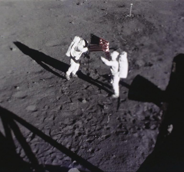 Astronauts Neil Armstrong and Buzz Aldrin place the American flag on the Moon. This image was captured by the Apollo 11 Data Acquisition Camera that was mounted to the lunar module Eagle.