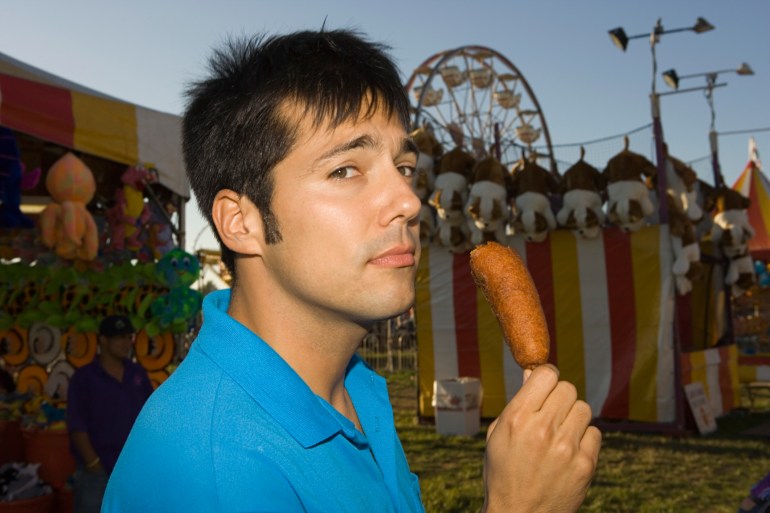 Man eating a corn dog 