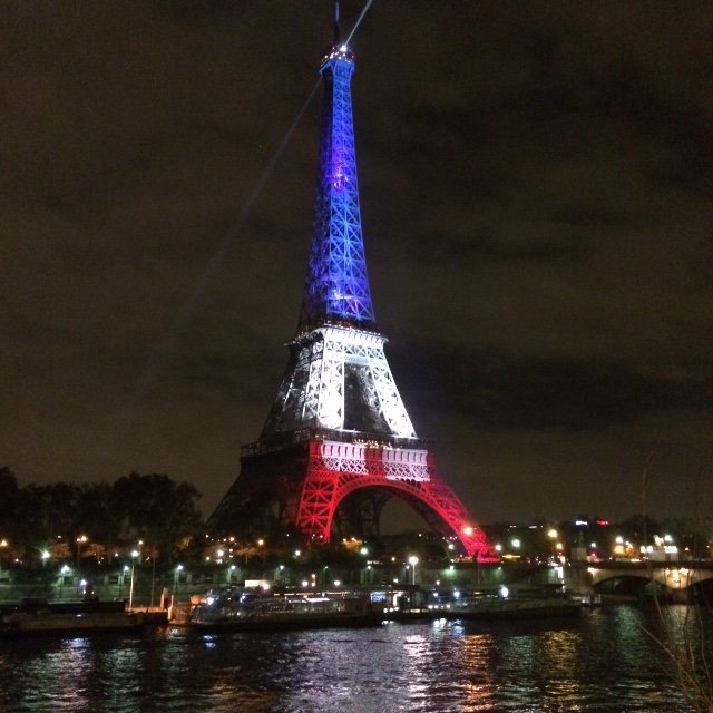 As Paris mourns after the terrorist attacks, the Eiffel Tower was lit up Monday evening in France's tricolor.