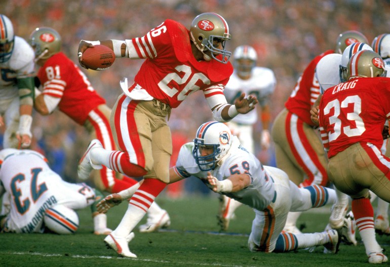 STANFORD, CA - JANUARY 20: Wendell Tyler #26 of the San Francisco 49ers works to escape a tackle during Super Bowl XIX against the Miami Dolphins at Stanford Stadium on January 20, 1985 in Stanford, California. The 49ers defeated the Dolphins 38 to16. (Photo by Tony Duffy/Getty Images)