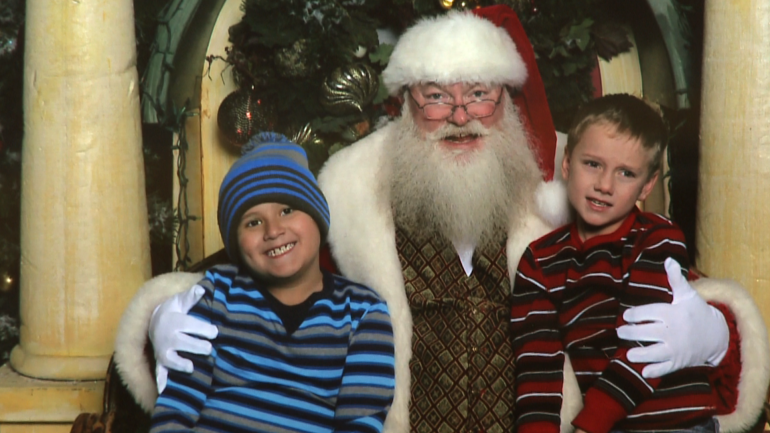 Colin (L) and Cavin (R) Chatham pose with Santa Claus at 2016's Irving Mall Sensitive Santa event.