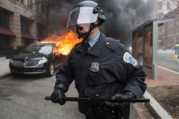 WASHINGTON, USA - JANUARY 20: Anti-Trump protestors set a limousine on fire during clashes with police after President Trump was sworn into office in Washington, USA on January 20, 2017. (Photo by Samuel Corum/Anadolu Agency/Getty Images)