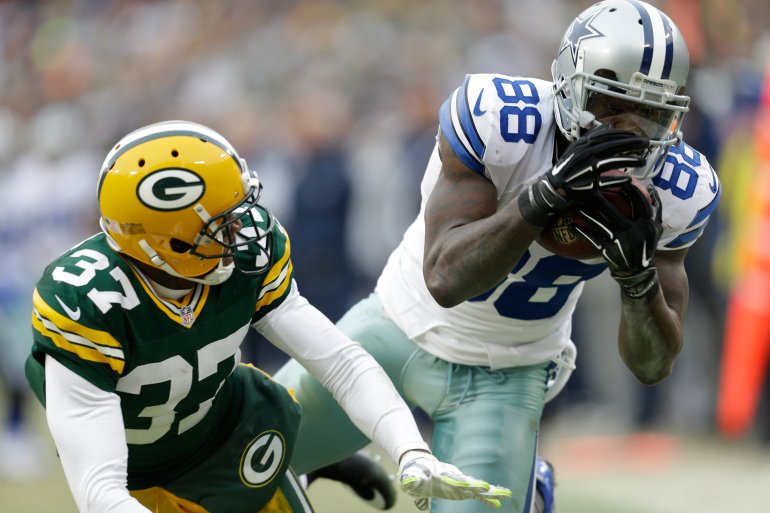 GREEN BAY, WI - JANUARY 11: Dez Bryant #88 of the Dallas Cowboys attempts a catch over Sam Shields #37 of the Green Bay Packers during the 2015 NFC Divisional Playoff game at Lambeau Field on January 11, 2015 in Green Bay, Wisconsin. Initially ruled a catch, the call was reversed upon review. (Photo by Mike McGinnis/Getty Images)