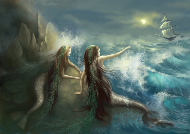 Hunting two mermaids in the rocks on the background of a stormy ocean and the raging waves. Getty