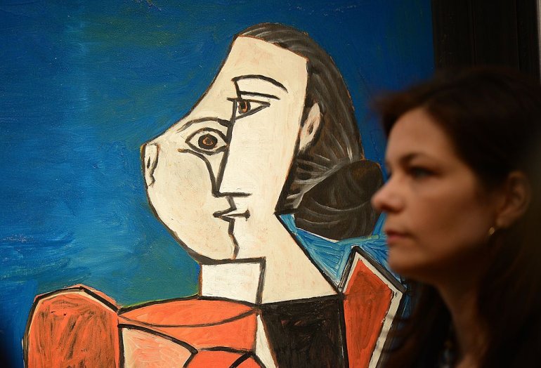 "Femme assise en costume rouge sur fond bleu" by Pablo Picasso is on display during a preview of Christie's Impressionist and Modern Art sales in New York on May 3, 2013. Christie's is scheduled to hold its Impressionist and Modern Art sales May 8-9. AFP PHOTO/Emmanuel Dunand ++RESTRICTED TO EDITORIAL USE, MANDATORY MENTION OF THE ARTIST UPON PUBLICATION, TO ILLUSTRATE THE EVENT AS SPECIFIED IN THE CAPTION++ (Photo credit should read EMMANUEL DUNAND/AFP/Getty Images)